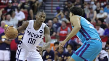 LAS VEGAS, NEVADA - JULY 08: Bennedict Mathurin #0 of the Indiana Pacers is guarded by Justin Minaya #14 of the Charlotte Hornets during the 2022 NBA Summer League at the Thomas & Mack Center on July 08, 2022 in Las Vegas, Nevada. NOTE TO USER: User expressly acknowledges and agrees that, by downloading and or using this photograph, User is consenting to the terms and conditions of the Getty Images License Agreement. (Photo by Ethan Miller/Getty Images)