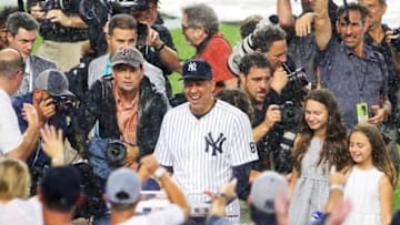 Aug 12, 2016; Bronx, NY, USA; New York Yankees designated hitter Alex Rodriguez (13) is surrounded by the media during a rainstorm during a pregame ceremony honoring him prior to him playing in his last game as a Yankee prior to the game against the Tampa Bay Rays at Yankee Stadium. Mandatory Credit: Andy Marlin-USA TODAY Sports