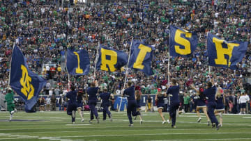 Oct 29, 2016; South Bend, IN, USA; Notre Dame Fighting Irish cheerleaders run with flags after a Notre Dame score against the Miami Hurricanes at Notre Dame Stadium. Mandatory Credit: Brian Spurlock-USA TODAY Sports