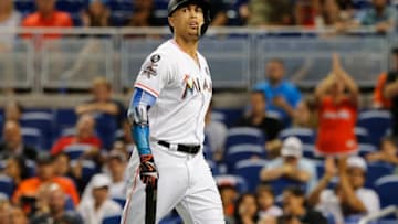 MIAMI, FL - OCTOBER 1: Giancarlo Stanton #27 of the Miami Marlins walks to the dugout striking out in the ninth inning of play against the Atlanta Braves, ending his bid for 60 home runs for the season at Marlins Park on October 1, 2017 in Miami, Florida. (Photo by Joe Skipper/Getty Images)