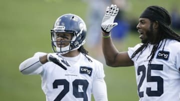Jun 12, 2013; Renton, WA, USA; Seattle Seahawks safety Earl Thomas (29) and cornerback Richard Sherman (25) give a high-five to a teammate after a play in minicamp practice at the Virginia Mason Athletic Center. Mandatory Credit: Joe Nicholson-USA TODAY Sports