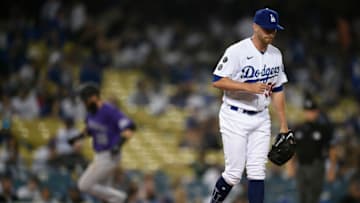 Jul 23, 2021; Los Angeles, California, USA; Los Angeles Dodgers relief pitcher Jimmie Sherfy (58) reacts after allowing a two-run home run to Colorado Rockies right fielder Charlie Blackmon (left) during the tenth inning at Dodger Stadium. Mandatory Credit: Kelvin Kuo-USA TODAY Sports