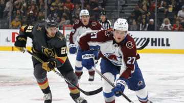 LAS VEGAS, NEVADA - SEPTEMBER 28: Oskar Olausson #27 of the Colorado Avalanche skates with the puck against Brett Howden #21 of the Vegas Golden Knights in the first period of their preseason game at T-Mobile Arena on September 28, 2021 in Las Vegas, Nevada. (Photo by Ethan Miller/Getty Images)