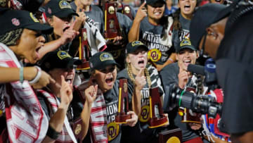 Oklahoma players celebrate with the trophy after defeating Texas in the NCAA Women's College World Series softball finals at USA Softball Hall of Fame Stadium in Oklahoma City, Thursday, June 9, 2022. Oklahoma won the second game 10-5 to sweep Texas for the NCAA softball title.Wcws
