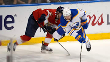 Dec 2, 2021; Sunrise, Florida, USA; Florida Panthers left wing Jonathan Huberdeau (11) is called for a tripping penalty on Buffalo Sabres defenseman Mark Pysyk (13) during the third period at FLA Live Arena. Mandatory Credit: Jasen Vinlove-USA TODAY Sports