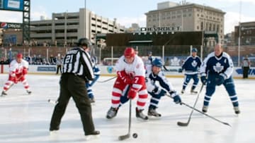 Dec 31, 2013; Detroit, MI, USA; Detroit Red Wings former forward Red Berenson (7) and Toronto Maple Leafs former forward Claude Loiselle (15) battle for the puck during the Alumni Showdown as part of the Winter Classic at Comerica Park. Mandatory Credit: Tim Fuller-USA TODAY Sports