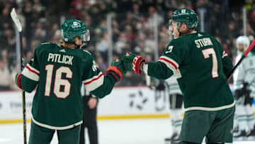 Nov 18, 2021; Saint Paul, Minnesota, USA; Minnesota Wild forward Rem Pitlick (16) celebrates his goal with forward Nico Sturm (7) during the first period against the Dallas Stars at Xcel Energy Center. Mandatory Credit: Brace Hemmelgarn-USA TODAY Sports
