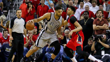 Apr 15, 2015; New Orleans, LA, USA; San Antonio Spurs forward Tim Duncan (21) is defended by New Orleans Pelicans forward Anthony Davis (23) during a game at the Smoothie King Center. The Pelicans defeated the Spurs 108-103 and earned the 8th seed in the Western Conference Playoffs. Mandatory Credit: Derick E. Hingle-USA TODAY Sports