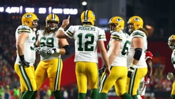 Jan 16, 2016; Glendale, AZ, USA; Green Bay Packers quarterback Aaron Rodgers (12) reacts in the huddle with teammates against the Arizona Cardinals in the first quarter of a NFC Divisional round playoff game at University of Phoenix Stadium. Mandatory Credit: Mark J. Rebilas-USA TODAY Sports