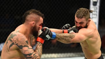 WINNIPEG, CANADA - DECEMBER 16: (R-L) Mike Perry punches Santiago Ponzinibbio of Argentina in their welterweight bout during the UFC Fight Night event at Bell MTS Place on December 16, 2017 in Winnipeg, Manitoba, Canada. (Photo by Josh Hedges/Zuffa LLC/Zuffa LLC via Getty Images)