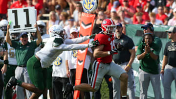Brock Bowers runs past Justin Thomas for a touchdown. (Photo by Brett Davis/Getty Images)