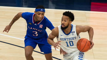 Dec 1, 2020; Indianapolis, IN, USA; Kentucky Wildcats guard Davion Mintz (10) drives to the basket against Kansas Jayhawks guard Dajuan Harris (3) in the second half at Bankers Life Fieldhouse. Mandatory Credit: Trevor Ruszkowski-USA TODAY Sports