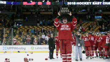 BOSTON, MA - MARCH 17: Boston University Terriers forward Brady Tkachuk (27) hoists the Lou Lamoniello Trophy after the Hockey East championship game between the Boston University Terriers and the Providence College Friars on March 18, 2018, at TD Garden in Boston, Massachusetts. The Terriers defeated the Friars 2-0. (Photo by Fred Kfoury III/Icon Sportswire via Getty Images)