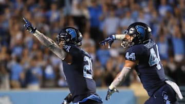 CHAPEL HILL, NORTH CAROLINA - OCTOBER 26: Teammates Jeremiah Gemmel #44 and Chazz Surratt #21 of the North Carolina Tar Heels react after a play during their game against the Duke Blue Devils at Kenan Stadium on October 26, 2019 in Chapel Hill, North Carolina. (Photo by Streeter Lecka/Getty Images)
