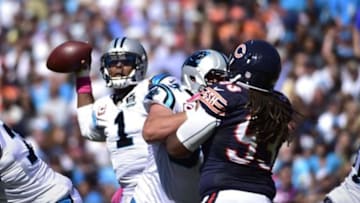 Oct 5, 2014; Charlotte, NC, USA; Carolina Panthers quarterback Cam Newton (1) throws a touchdown pass as Chicago Bears defensive tackle Will Sutton (93) pressures in the second quarter at Bank of America Stadium. Mandatory Credit: Bob Donnan-USA TODAY Sports