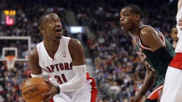 Apr 14, 2014; Toronto, Ontario, CAN; Toronto Raptors guard Terrence Ross (31) goes to pass as Milwaukee Bucks forward Khris Middleton (22) defends during the first half at the Air Canada Centre. Mandatory Credit: John E. Sokolowski-USA TODAY Sports