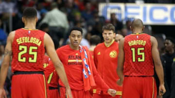 Nov 24, 2015; Atlanta, GA, USA; Atlanta Hawks guard Jeff Teague (0, center) greets guard Thabo Sefolosha (25) and center Al Horford (15) during a timeout in the fourth quarter of their game against the Boston Celtics at Philips Arena. The Hawks won 121-97. Mandatory Credit: Jason Getz-USA TODAY Sports