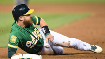 OAKLAND, CA - MARCH 30: Jonathan Lucroy #21 of the Oakland Athletics lays on ground at first base after he was picked off against the Los Angeles Angels of Anaheim in the bottom of the seventh inning at Oakland Alameda Coliseum on March 30, 2018 in Oakland, California. (Photo by Thearon W. Henderson/Getty Images)