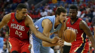 Oct 26, 2016; New Orleans, LA, USA; Denver Nuggets forward Danilo Gallinari (8) is fouled by New Orleans Pelicans center Alexis Ajinca (42) in the first quarter at the Smoothie King Center. Mandatory Credit: Chuck Cook-USA TODAY Sports