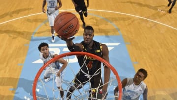 Dec 1, 2015; Chapel Hill, NC, USA; Maryland Terrapins forward Robert Carter (4) shoots as North Carolina Tar Heels guard Marcus Paige (5) and guard Joel Berry II (2) defend in the first half. The Tar Heels defeated the Terrapins 89-81 at Dean E. Smith Center. Mandatory Credit: Bob Donnan-USA TODAY Sports