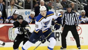 Nov 25, 2015; Pittsburgh, PA, USA; St. Louis Blues defenseman Colton Parayko (55) moves the puck as Pittsburgh Penguins center Matt Cullen (7) pressures during the third period at the CONSOL Energy Center. The Penguins won 4-3 in overtime. Mandatory Credit: Charles LeClaire-USA TODAY Sports