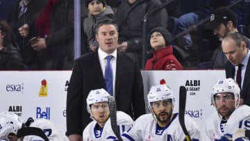 Toronto Maple Leafs - Coach Greg Moore looks on from behind the Toronto Marlies bench (Photo by Minas Panagiotakis/Getty Images)