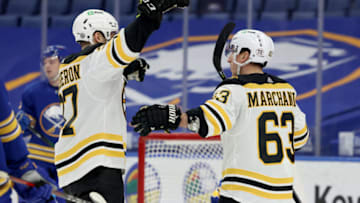 Apr 22, 2021; Buffalo, New York, USA; Boston Bruins center Brad Marchand (63) celebrates his goal with center Patrice Bergeron (37) during the first period against the Buffalo Sabres at KeyBank Center. Mandatory Credit: Timothy T. Ludwig-USA TODAY Sports