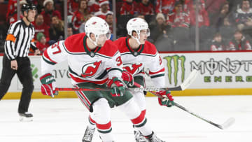 NEWARK, NJ - DECEMBER 20: Pavel Zacha #37 of the New Jersey Devils and Jack Hughes #86 keep their eyes ont he puck during the game against the Washington Capitals at the Prudential Center on December 20, 2019 in Newark, New Jersey. (Photo by Andy Marlin/NHLI via Getty Images)