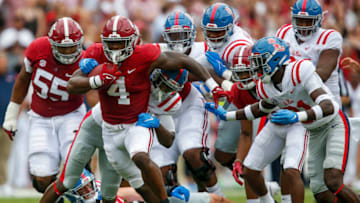 Oct 2, 2021; Tuscaloosa, Alabama, USA; Alabama running back Brian Robinson Jr. (4) fights for yardage against Ole Miss defenders at Bryant-Denny Stadium. Mandatory Credit: Gary Cosby-USA TODAY Sports