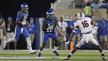 Sep 24, 2016; Lexington, KY, USA; Kentucky Wildcats running back Stanley Boom Williams (18) runs the ball against South Carolina Gamecocks defensive back Rashad Fenton (16) in the second half at Commonwealth Stadium. Kentucky defeated South Carolina 17-10. Mandatory Credit: Mark Zerof-USA TODAY Sports