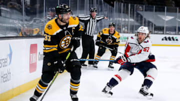 Apr 11, 2021; Boston, Massachusetts, USA; Washington Capitals left wing Carl Hagelin (62) defends Boston Bruins center Patrice Bergeron (37) at TD Garden. Mandatory Credit: Paul Rutherford-USA TODAY Sports