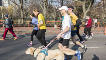 BOSTON, MA - APRIL 14: Guiding Eyes for the Blind President & CEO Thomas Panek participates in the BAA 5K guided by his guide dog Gus, accompanied by ultra-runner Scott Jurek, kicking off the Guiding Eyes Wag-a-thon on April 14, 2018 in Boston, Massachusetts. (Photo by Scott Eisen/Getty Images for Guiding Eyes for the Blind)