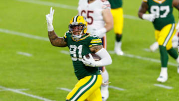 Nov 29, 2020; Green Bay, Wisconsin, USA; Green Bay Packers outside linebacker Preston Smith (91) returns a fumble recovery for a touchdown during the second quarter against the Chicago Bears at Lambeau Field. Mandatory Credit: Jeff Hanisch-USA TODAY Sports