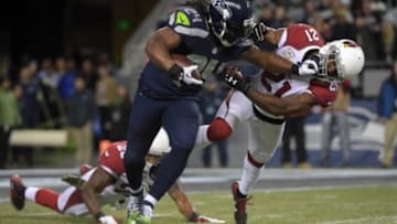 Nov 15, 2015; Seattle, WA, USA; Seattle Seahawks running back Marshawn Lynch (24) is defended by Arizona Cardinals cornerback Patrick Peterson (21) during a NFL football game at CenturyLink Field. Mandatory Credit: Kirby Lee-USA TODAY Sports