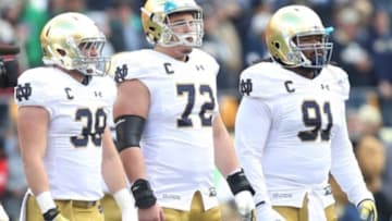 Nov 7, 2015; Pittsburgh, PA, USA; Notre Dame Fighting Irish game captains linebacker Joe Schmidt (38) and center Nick Martin (72) and defensive lineman Sheldon Day (91) line up for the coin toss against the Pittsburgh Panthers at Heinz Field. Notre Dame won 42-30. Mandatory Credit: Charles LeClaire-USA TODAY Sports