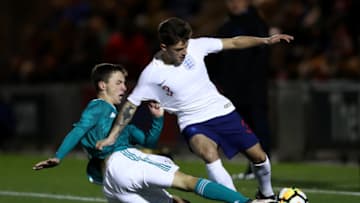 COLCHESTER, ENGLAND - NOVEMBER 19: Adam Lewis of England is tackled by Benjamin Goller of Germany during the international friendly match between England U20 and Germany U20 at Colchester Community Stadium on November 19, 2018 in Colchester, England. (Photo by Bryn Lennon/Getty Images)