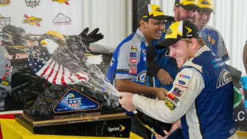 Aug 1, 2016; Long Pond, PA, USA; NASCAR Sprint Cup Series driver Chris Buescher celebrates in victory lane after winning the Pennsylvania 400 at Pocono Raceway. Mandatory Credit: Matthew O