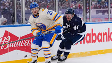Mar 13, 2022; Hamilton, Ontario, CAN; Buffalo Sabres forward Vinnie Hinostroza (29) skates against Toronto Maple Leafs defenseman Morgan Rielly (44) during the first period in the 2022 Heritage Classic ice hockey game at Tim Hortons Field. Mandatory Credit: John E. Sokolowski-USA TODAY Sports