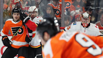 PHILADELPHIA, PA - NOVEMBER 23: Scott Laughton #21 of the Philadelphia Flyers battles for position next to goaltender David Rittich #33 of the Calgary Flames with Mark Giordano #5 on November 23, 2019 at the Wells Fargo Center in Philadelphia, Pennsylvania. (Photo by Len Redkoles/NHLI via Getty Images)