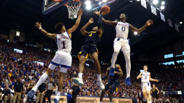 LAWRENCE, KANSAS - JANUARY 04: Marcus Garrett #0 of the Kansas Jayhawks swats the ball out of the hands of Miles McBride #4 of the West Virginia Mountaineers during the game at Allen Fieldhouse on January 04, 2020 in Lawrence, Kansas. (Photo by Jamie Squire/Getty Images)