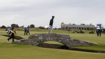 Jul 19, 2015; St. Andrews, Fife, SCT; Dustin Johnson walks over the Swilcan Bridge on the 18th hole during the third round of the 144th Open Championship at St. Andrews - Old Course. Mandatory Credit: Brian Spurlock-USA TODAY Sports