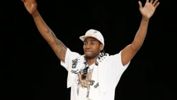 Jun 18, 2014; San Antonio, TX, USA; San Antonio Spurs forward Kawhi Leonard (2) waves to the crowd during NBA championship celebrations at Alamodome. Mandatory Credit: Soobum Im-USA TODAY Sports