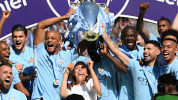 MANCHESTER, ENGLAND - MAY 06: Vincent Kompany of Manchester City lifts the Premier League Trophy as Manchester City celebrate winning the Premier League after the Premier League match between Manchester City and Huddersfield Town at Etihad Stadium on May 6, 2018 in Manchester, England. (Photo by Shaun Botterill/Getty Images)