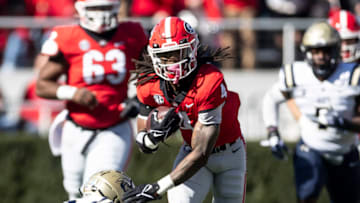 James Cook #4 avoids a tackle by Dominic Pagano #32 during a game between Charleston Southern Buccaneers and Georgia Bulldogs at Sanford Stadium on November 20, 2021 in Athens, Georgia. (Photo by Steven Limentani/ISI Photos/Getty Images)