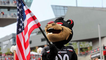 Cincinnati Bearcat mascot holds the American Flag. USA Today.