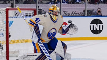 Mar 13, 2022; Hamilton, Ontario, CAN; Buffalo Sabres goaltender Craig Anderson (41) blocks a shot by the Toronto Maple Leafs during the second period in the 2022 Heritage Classic ice hockey game at Tim Hortons Field. Mandatory Credit: John E. Sokolowski-USA TODAY Sports