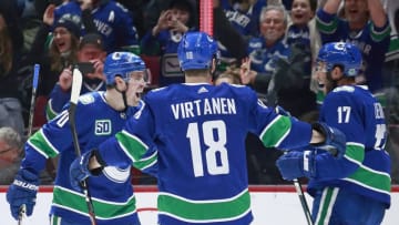 VANCOUVER, BC - DECEMBER 19: Tanner Pearson #70 of the Vancouver Canucks is congratulated by teammates Josh Leivo #17 and Jake Virtanen #18 after scoring during their NHL game against the Vegas Golden Knights at Rogers Arena December 19, 2019 in Vancouver, British Columbia, Canada. (Photo by Jeff Vinnick/NHLI via Getty Images)