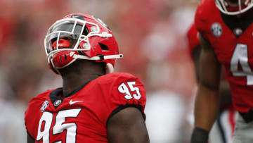 Oct 2, 2021; Athens, GA, USA; Georgia defensive lineman Devonte Wyatt (95) celebrates after taking down Arkansas quarterback KJ Jefferson (1) during the first half of an NCAA college football game between Arkansas and Georgia in Athens, Ga., on Saturday, Oct. 2, 2021. Mandatory Credit: Joshua L. Jones-USA TODAY Sports