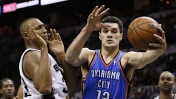 May 29, 2014; San Antonio, TX, USA; Oklahoma City Thunder center Steven Adams (12) grabs a loose ball in front of San Antonio Spurs forward Boris Diaw (33) during the first half in game five of the Western Conference Finals of the 2014 NBA Playoffs at AT&T Center. Mandatory Credit: Soobum Im-USA TODAY Sports