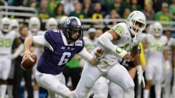 Jan 2, 2016; San Antonio, TX, USA; TCU Horned Frogs quarterback Bram Kohlhausen (6) is pressured by Oregon Ducks defensive lineman DeForest Buckner (44) during the 2016 Alamo Bowl at Alamodome. Mandatory Credit: Kirby Lee-USA TODAY Sports